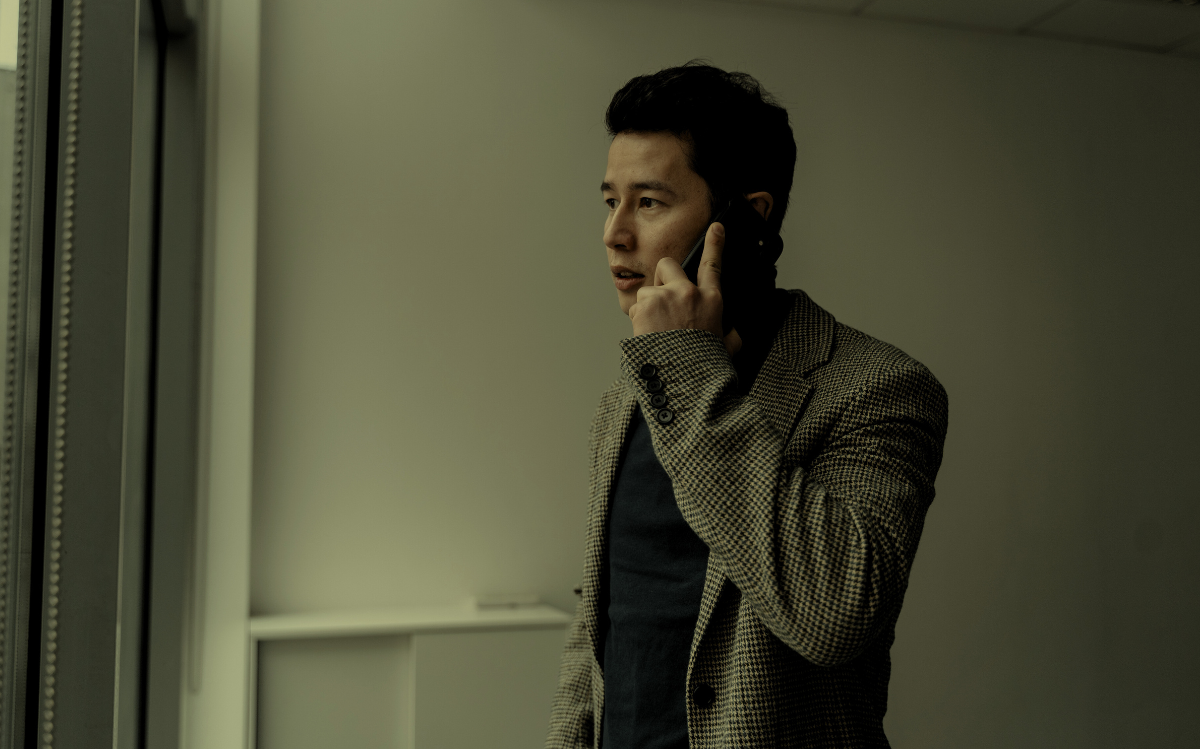 A man in a checkered jacket speaking on a mobile phone, suggesting the need for professional communication.